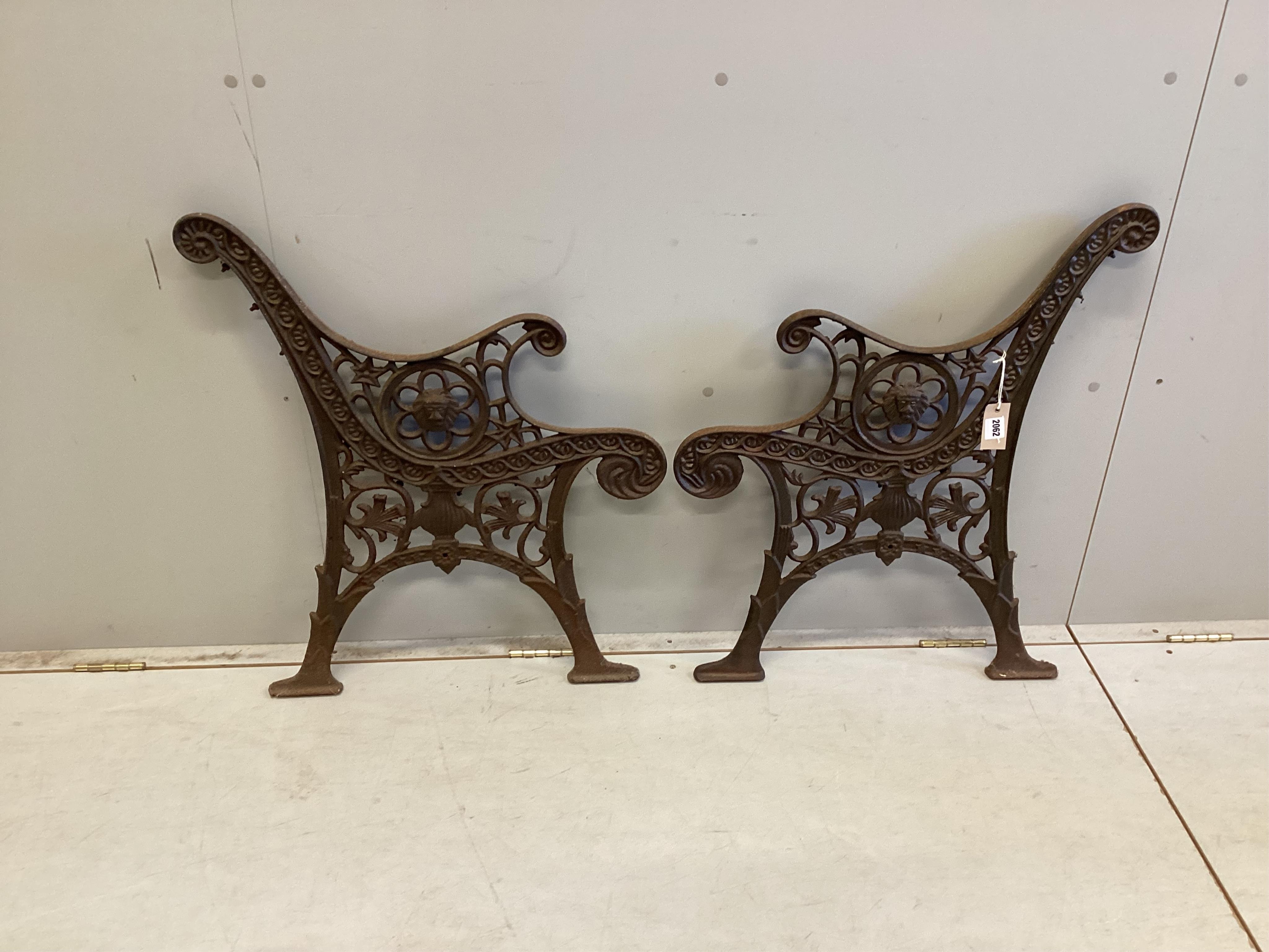 A pair of cast iron bench ends, each width 60cm, height 74cm